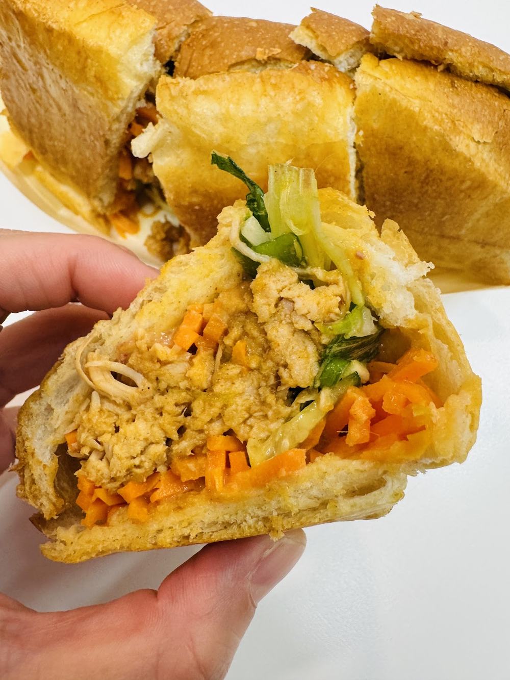Bánh mì held up outside the shop